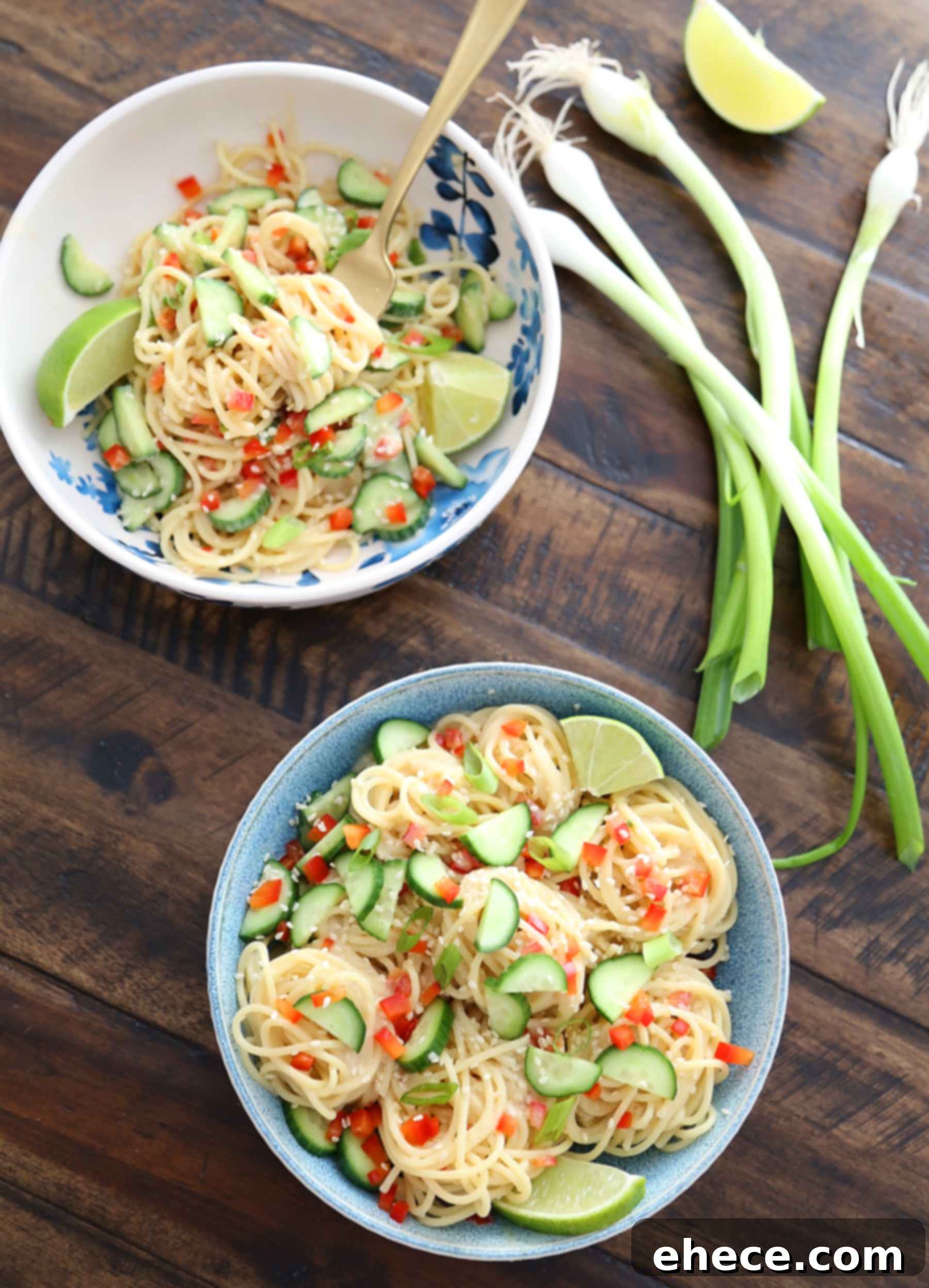 A hand mixing the cold noodles with the creamy miso dressing in a large bowl.