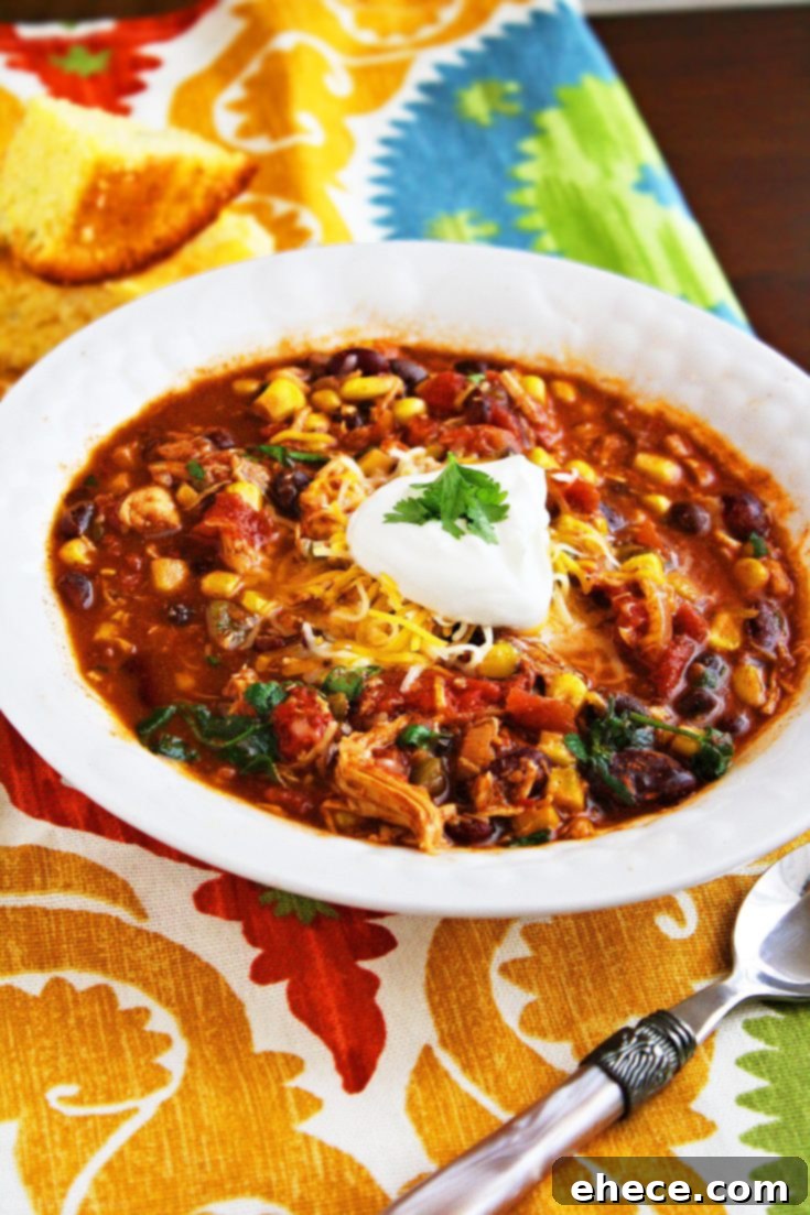 Crock Pot Chicken Taco Chili ready to serve with a variety of fresh toppings