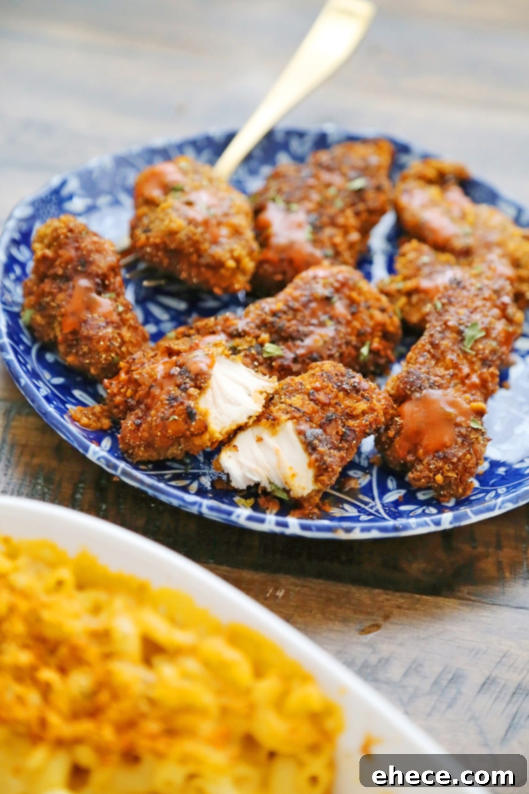 Close-up of freshly baked chicken tenders and a bowl of honey mustard sauce
