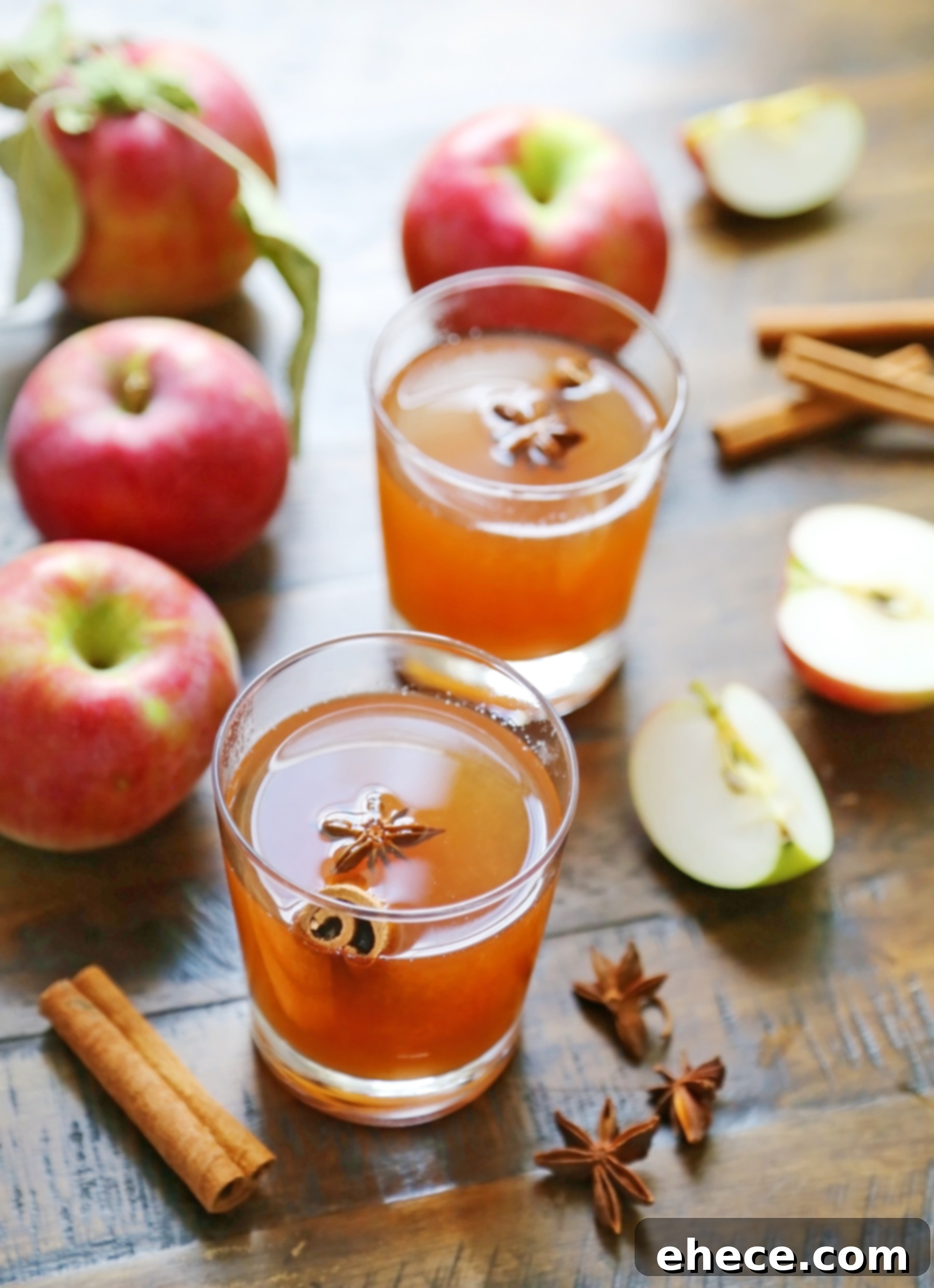 A close-up of a rustic pitcher filled with homemade apple cider