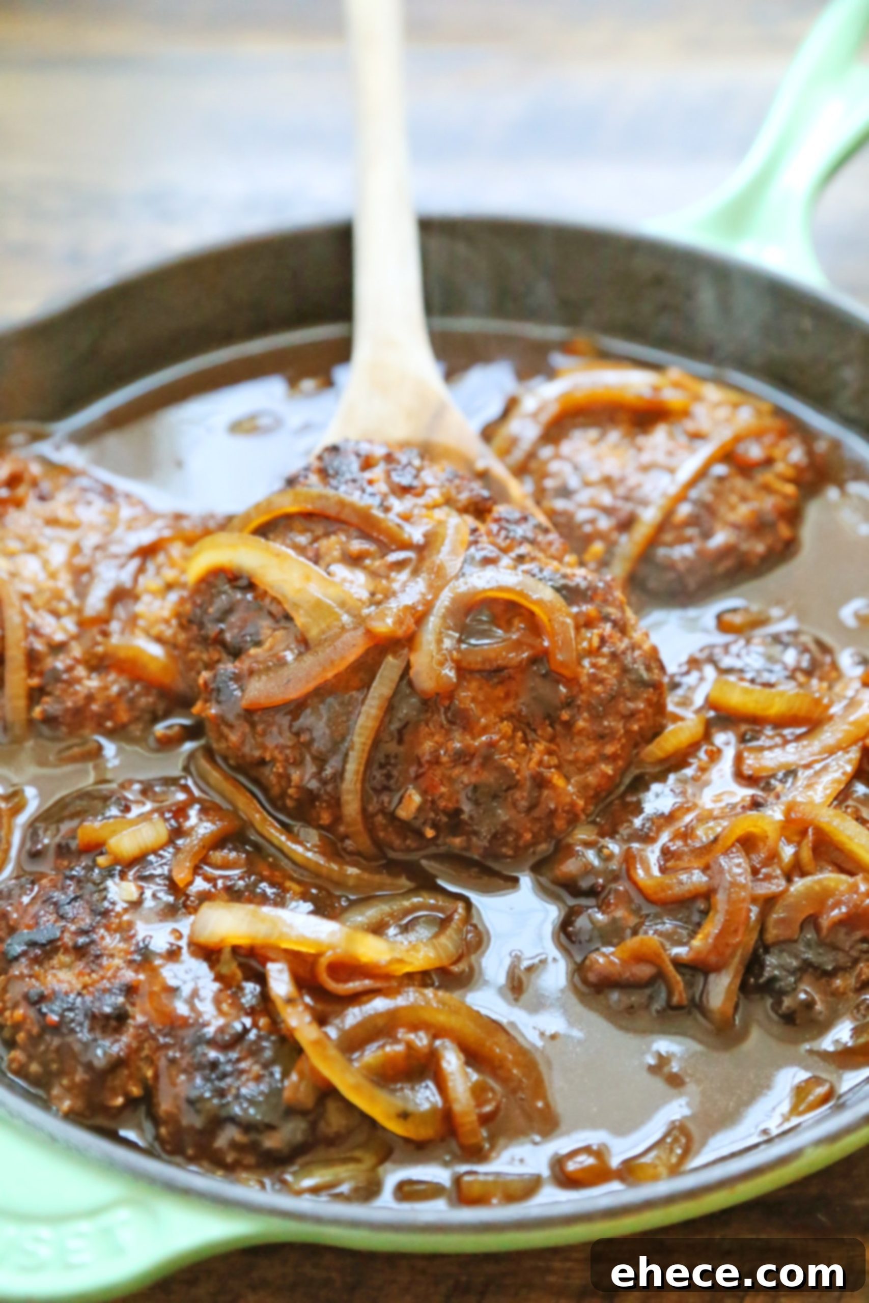 Close up of a Salisbury steak patty in gravy