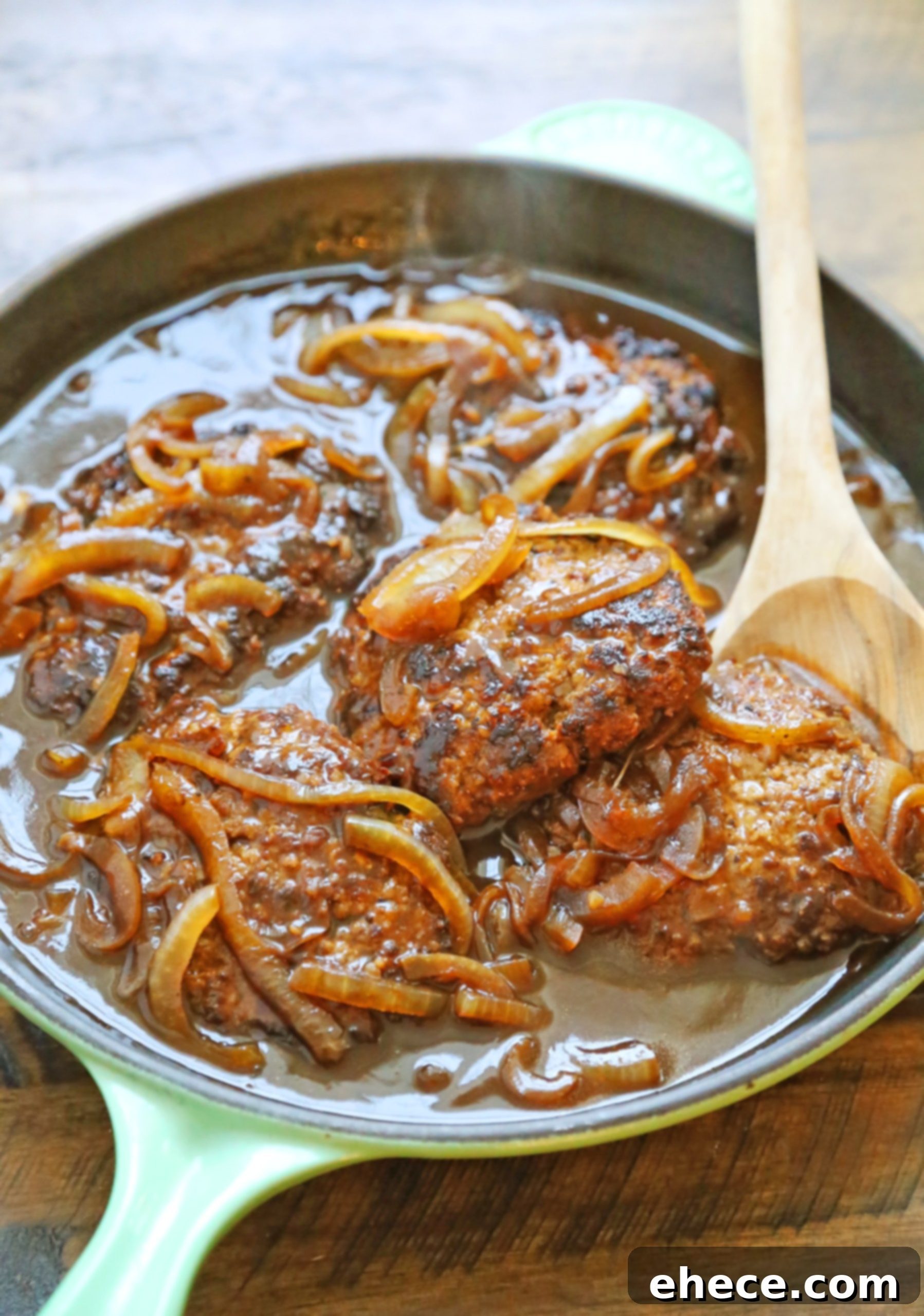 Serving dish of Skillet Salisbury Steak with a spoon