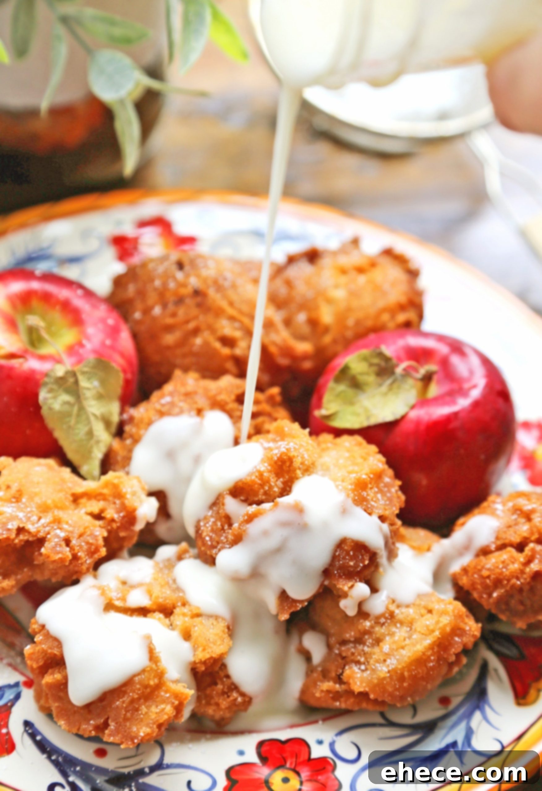 Close-up of freshly glazed apple fritters on a cooling rack