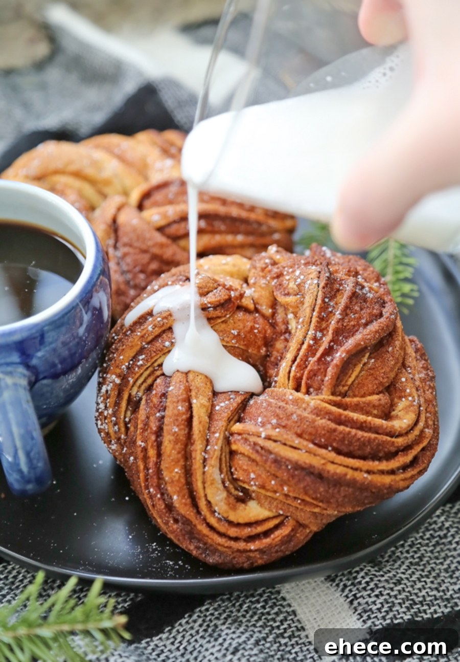 Four-Ingredient Cinnamon Swirl Wreath 6 A close-up of a slice of cinnamon wreath, revealing the soft, swirled interior.