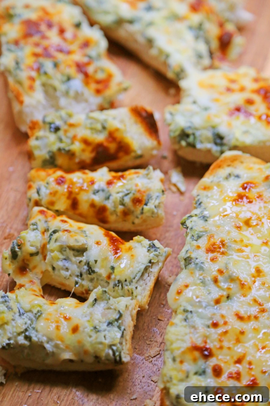 Three slices of cheesy spinach artichoke bread on a white platter, garnished with fresh parsley.