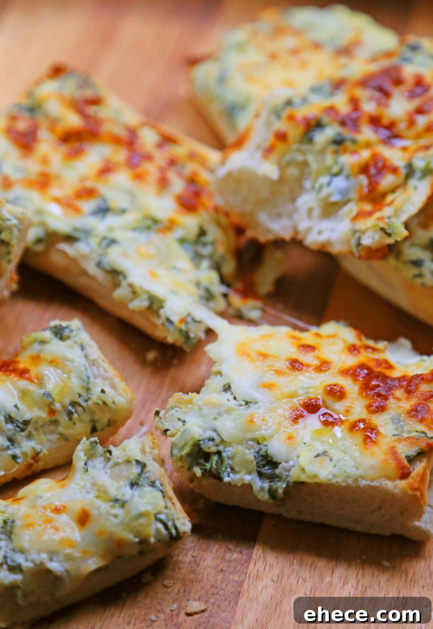 A large serving platter with multiple slices of golden brown, cheesy spinach artichoke bread, garnished with fresh herbs.