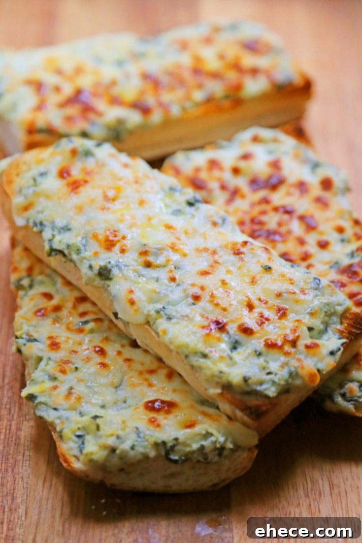 Cheesy Spinach-Artichoke Bread, golden brown and garnished.