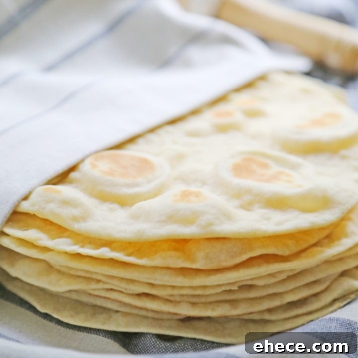 Pillowy Soft Homemade Flour Tortillas 7 Homemade Soft Flour Tortillas stacked and ready to serve.