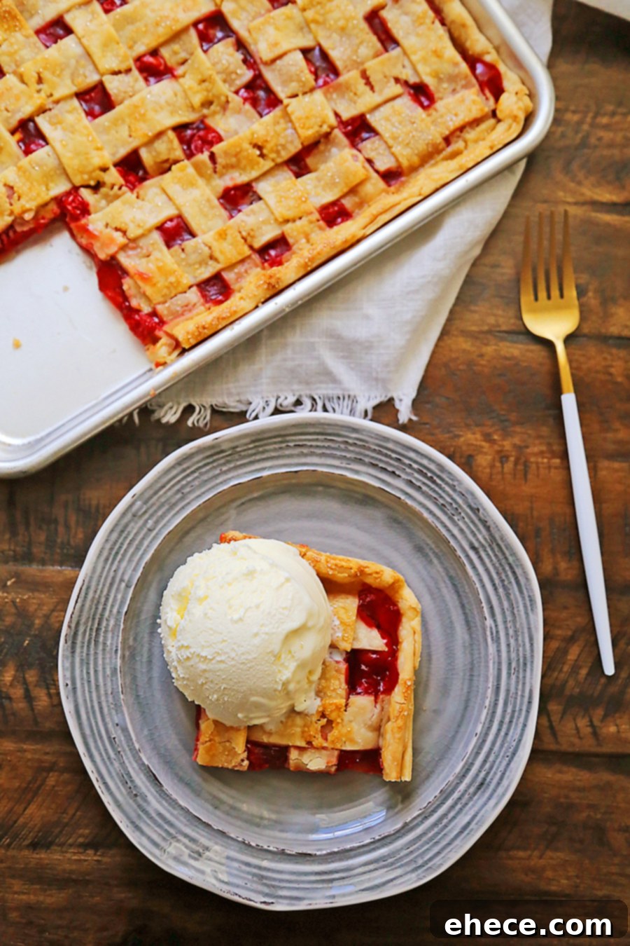 A beautifully baked 3-ingredient cherry slab pie cooling on a wooden board.