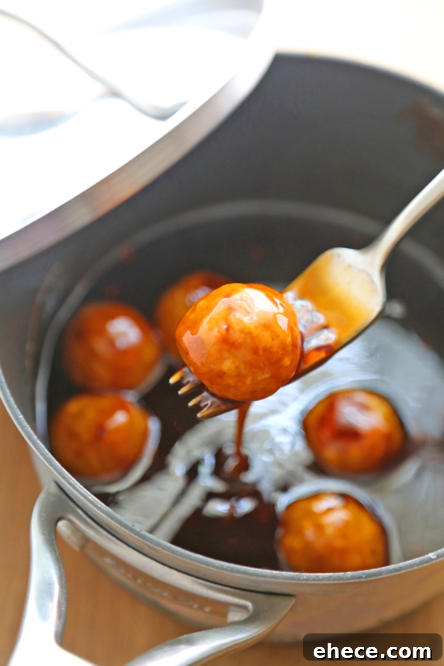 Dynamite Chicken Meatballs 3 Close-up of baked chicken meatballs on a baking sheet, ready for sauce