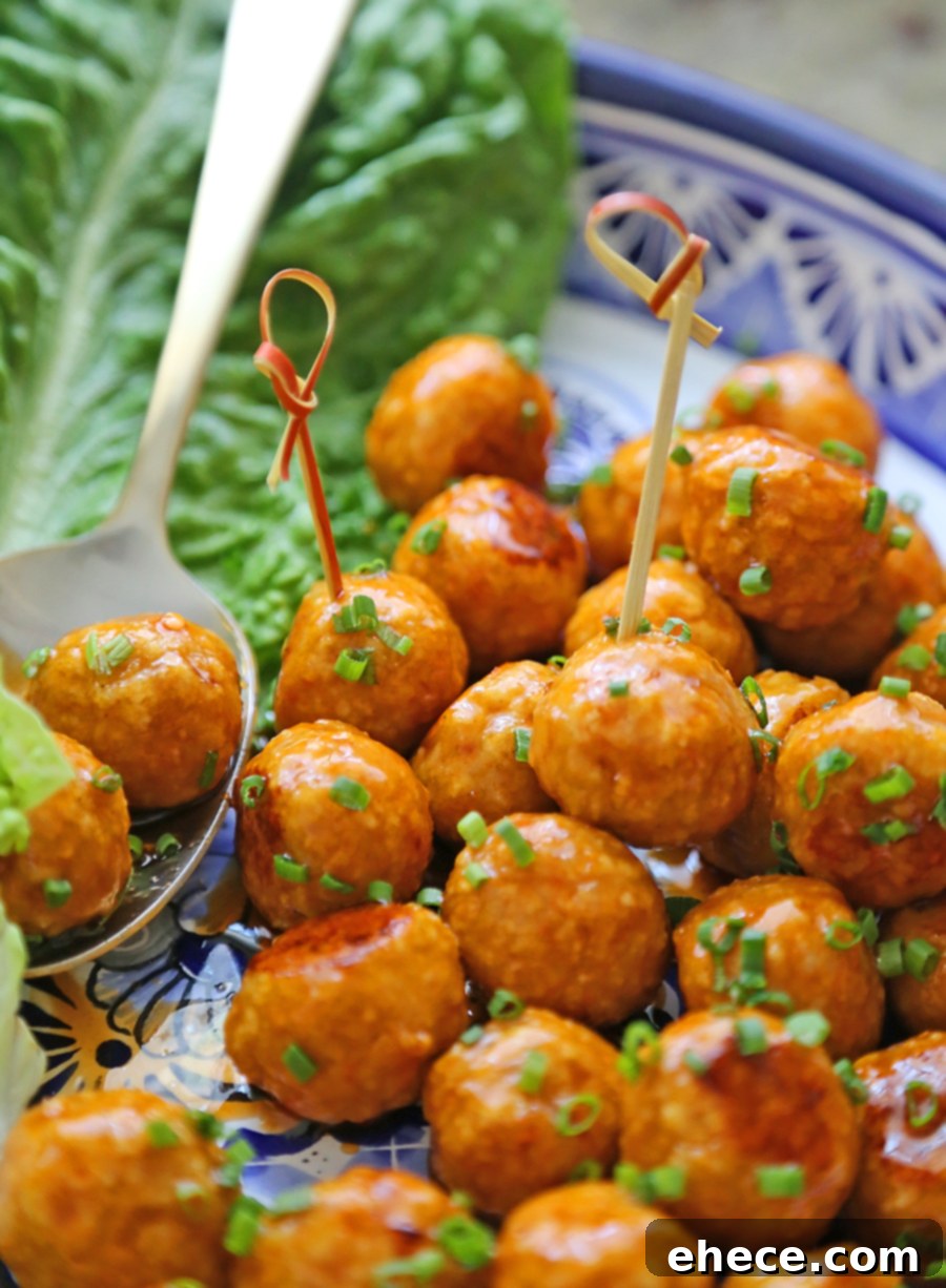 Dynamite Chicken Meatballs 5 Firecracker Chicken Meatballs in a bowl, glazed and ready to serve