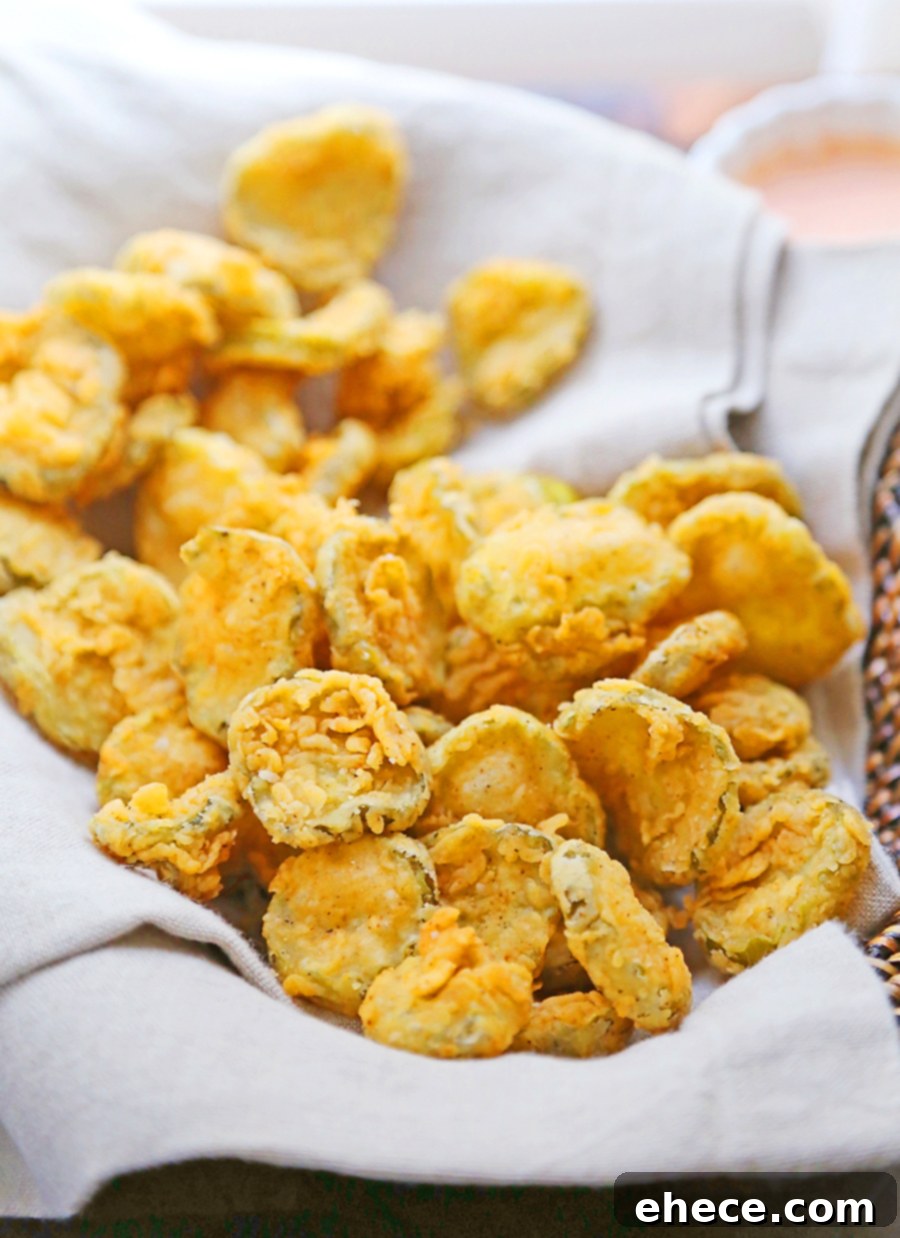 Closeup of crispy buttermilk fried pickles with dipping sauce
