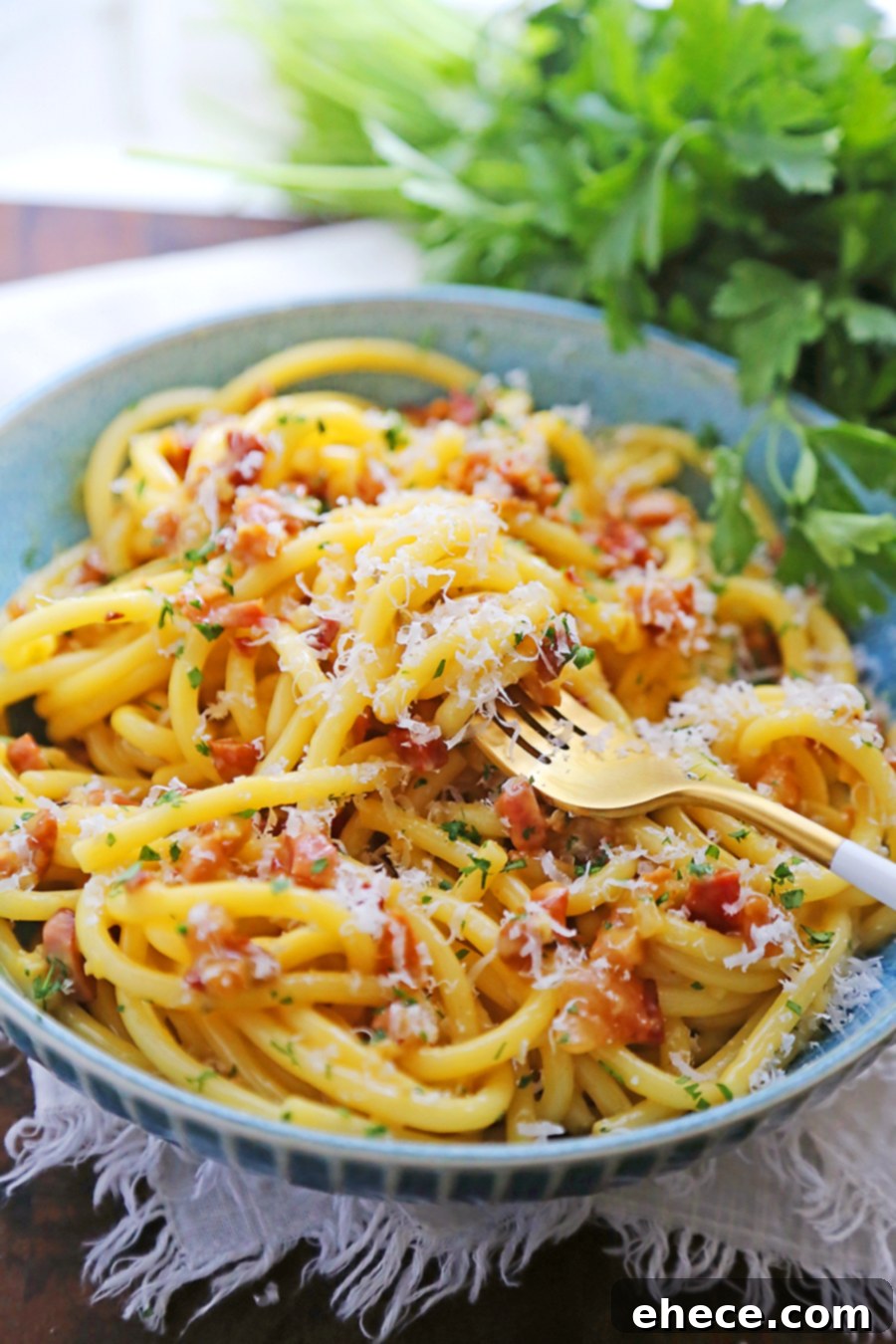 Delicious Bucatini Carbonara served in a bowl, ready to eat