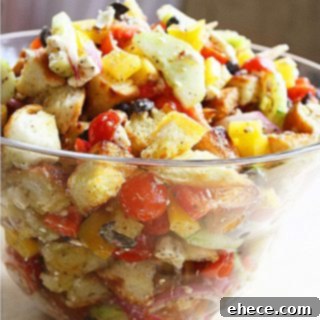 Refreshing Greek Summer Panzanella 2 A vibrant bowl of Greek Panzanella Salad with toasted bread, vegetables, and feta cheese.