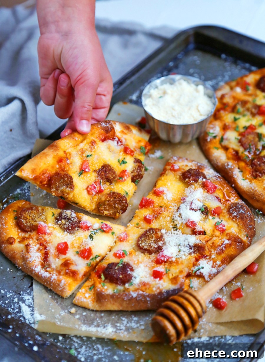Girl's hand stealing a slice of Meatball Flatbread Pizza