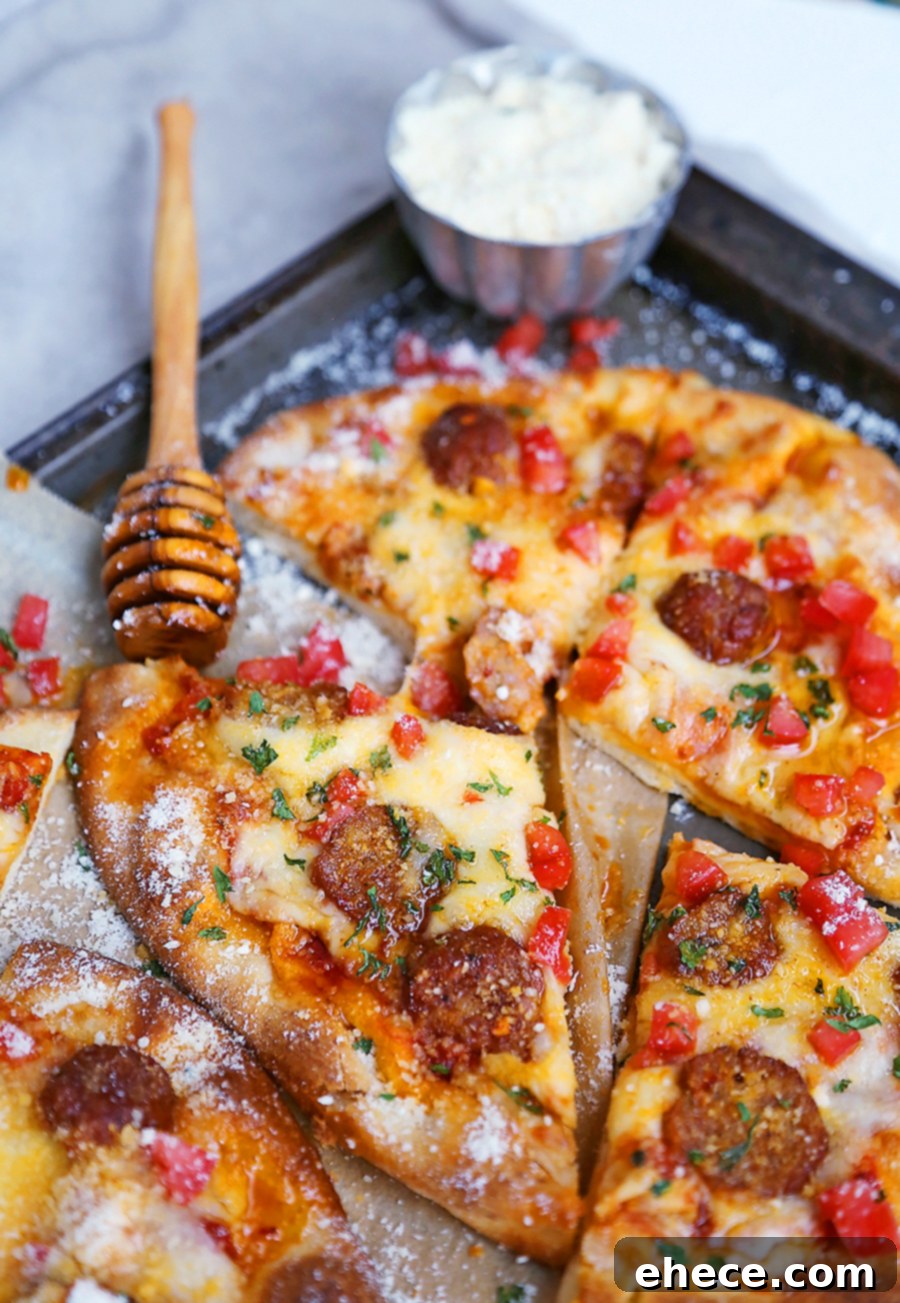 Two Meatball Flatbread Pizzas on a cutting board, ready to be sliced