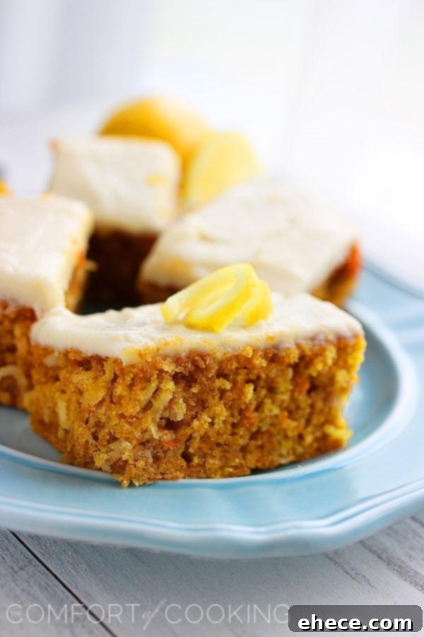 Freshly baked Carrot Cake Bars with decorative lemon spirals