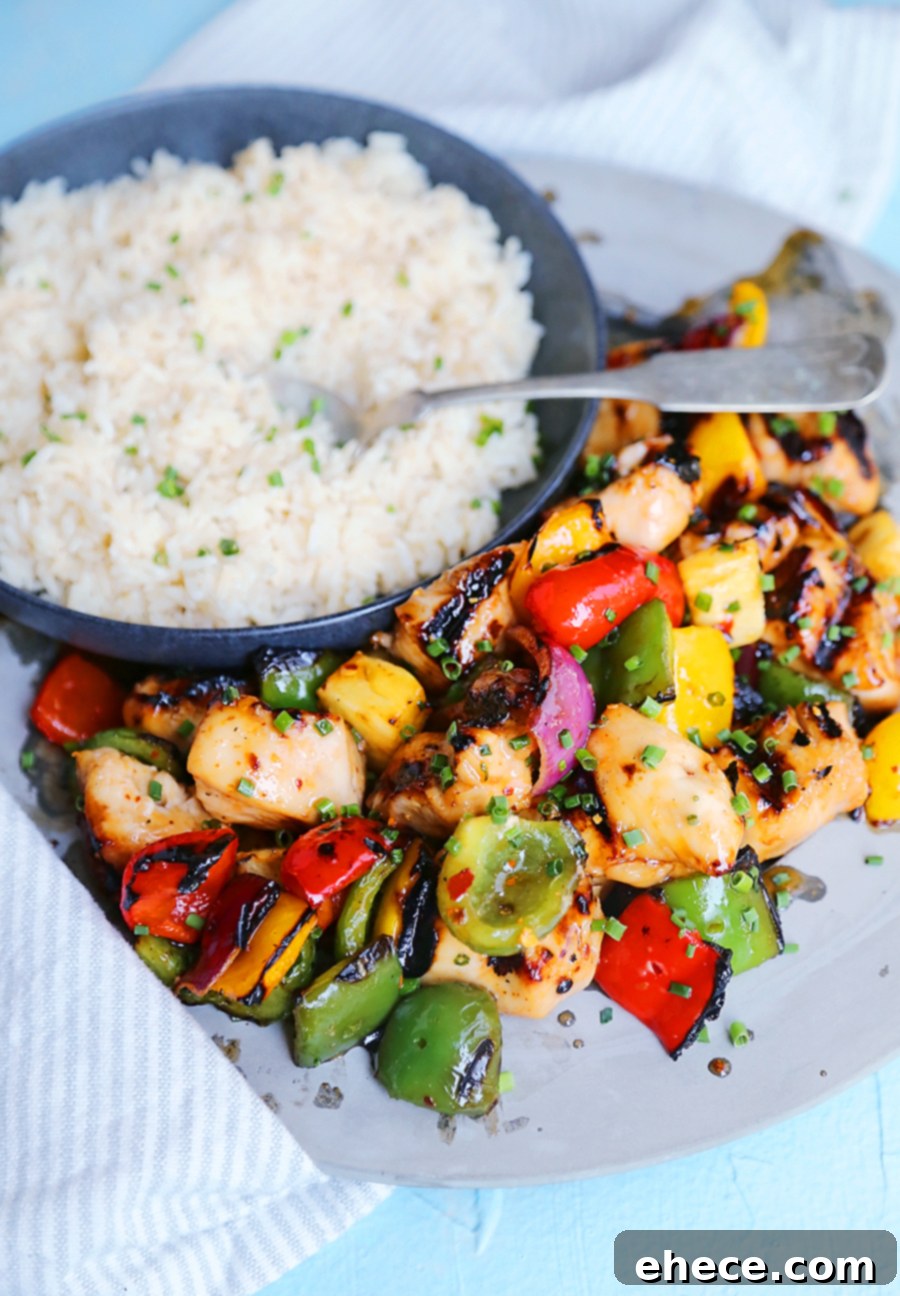 Island Glazed Chicken Skewers 7 Close-up of freshly grilled Sweet Chili Hawaiian Chicken Skewers on a white plate