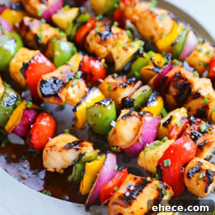 Island Glazed Chicken Skewers 8 Sweet Chili Hawaiian Chicken Skewers on a white plate with sauce