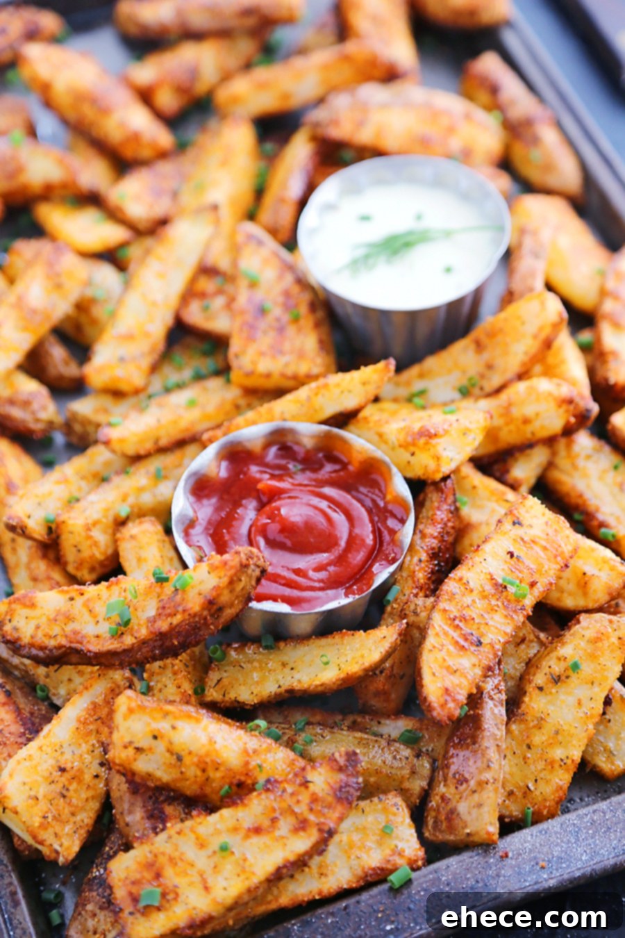 Close-up of crispy potato wedges with Parmesan and chives