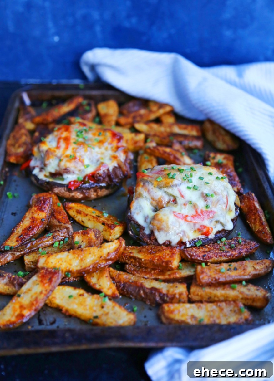 Philly Cheesesteak Portobello Boats 4 Philly Cheesesteak Stuffed Portobello Mushrooms on a serving board
