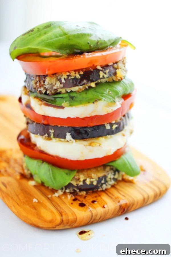 Tall stack of fresh Caprese salad with crispy eggplant