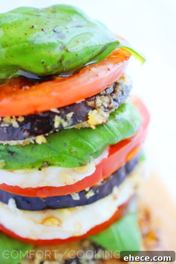 Close-up of crispy eggplant Caprese stack with dressing