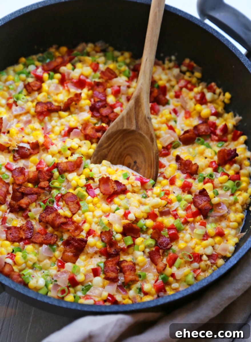 Festive Creamed Corn with Bacon 2 Creamy Confetti Corn with Bacon in a skillet, garnished with fresh herbs