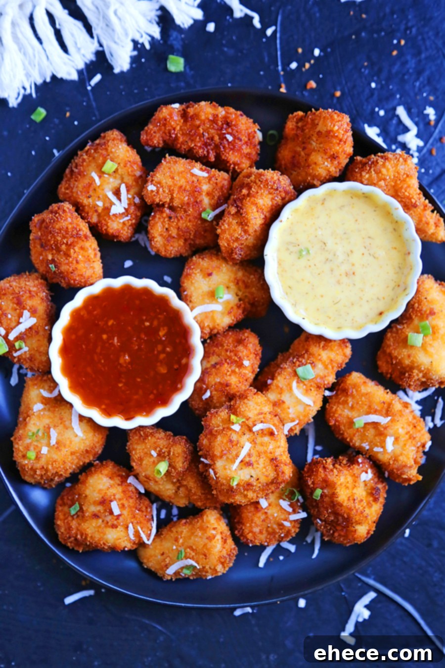 Tropical Crunch Popcorn Chicken 4 A delicious spread of crispy coconut popcorn chicken with a side of ramen noodles and cucumber salad, perfect for a family meal