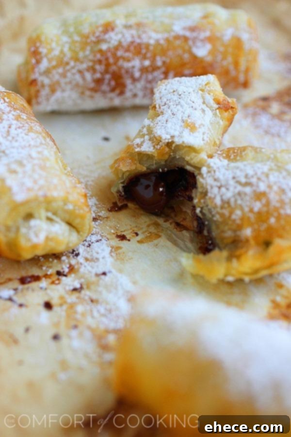 3-Ingredient Chocolate Croissant Hack 6 A baker brushing egg wash on unbaked chocolate croissants before chilling.