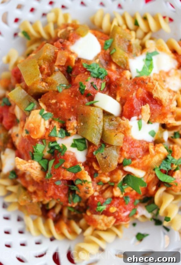 Slow Cooker Tuscan Tomato Chicken 3 Close-up of Slow Cooker Italian Chicken with Tomatoes with melted mozzarella