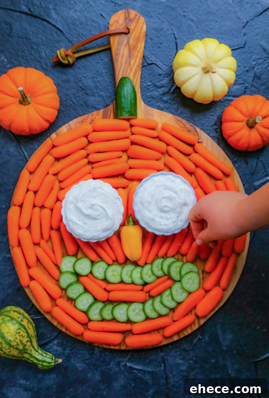 Delicious and healthy pumpkin-shaped Halloween veggie tray with Ranch dip.