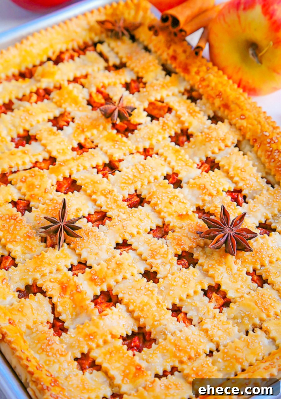 Sheet Pan Apple Pie Perfection 2 A perfectly baked, golden-brown Apple Slab Pie on a sheet pan, ready to be served as a delicious fall or holiday dessert. Ideal for feeding a crowd.