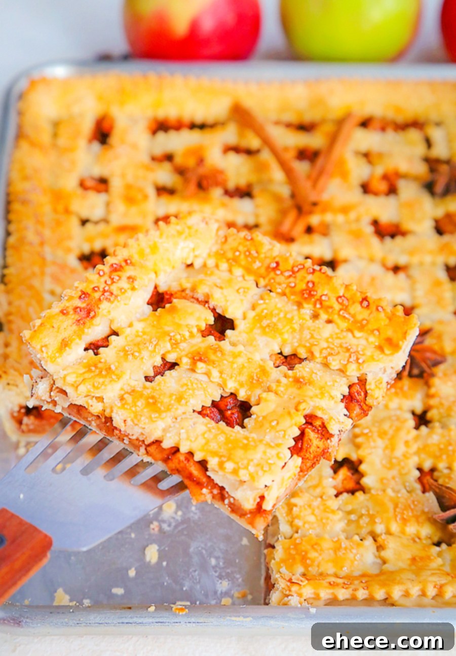 Sheet Pan Apple Pie Perfection 3 A partially baked Apple Slab Pie on a standard quarter sheet pan, showcasing the golden-brown lattice crust and apple filling. Perfect for holiday baking.