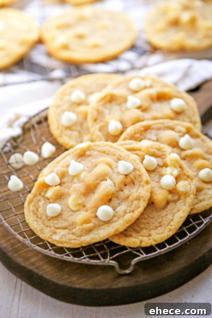 White chocolate macadamia nut cookies cooling on a wire rack
