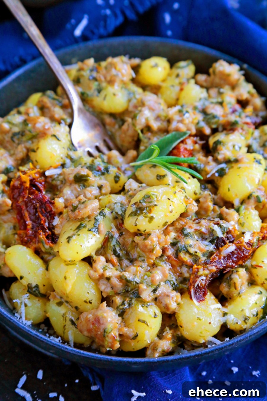 A close-up of Creamy Tuscan Sausage Gnocchi in a pan, steaming hot.