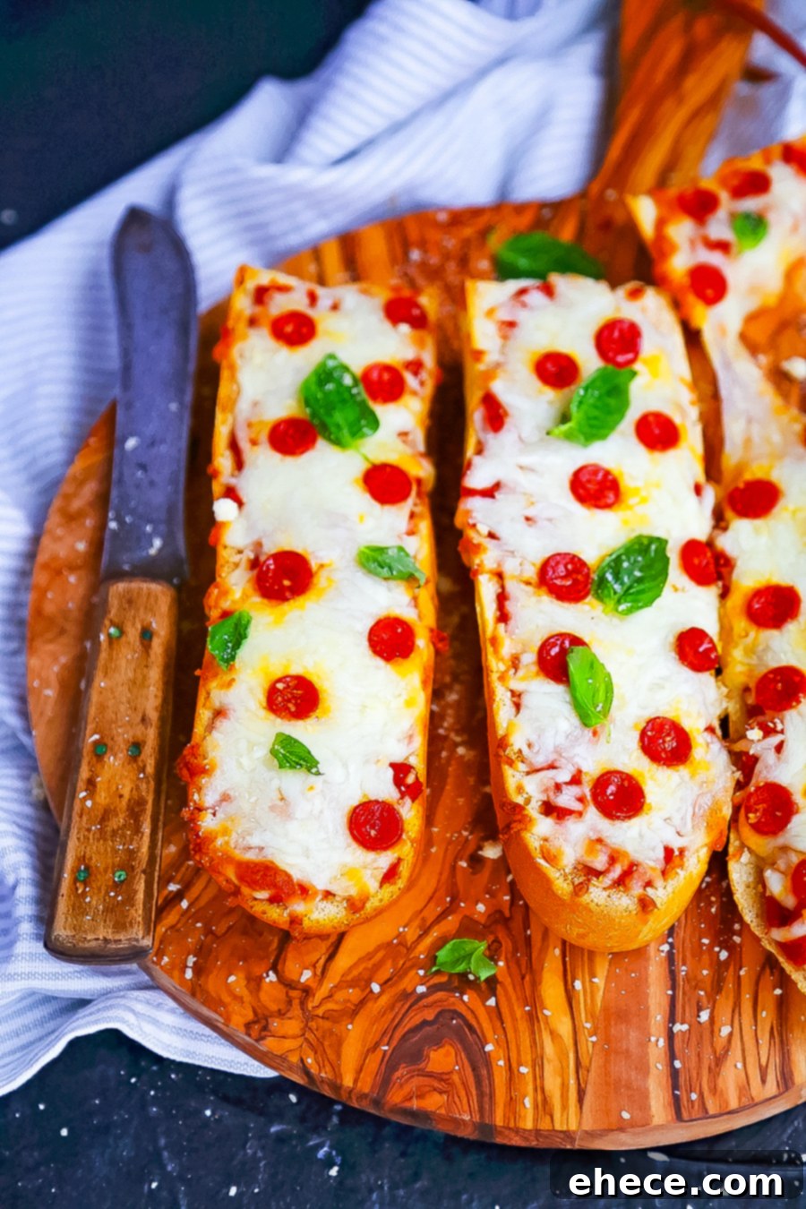 A selection of various French bread pizza toppings laid out, showcasing customization