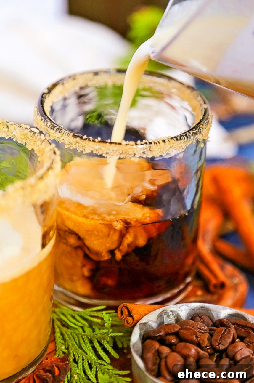 A close-up shot of a glass of Espresso Chai Eggnog, showcasing the creamy texture and garnished with fresh cinnamon.