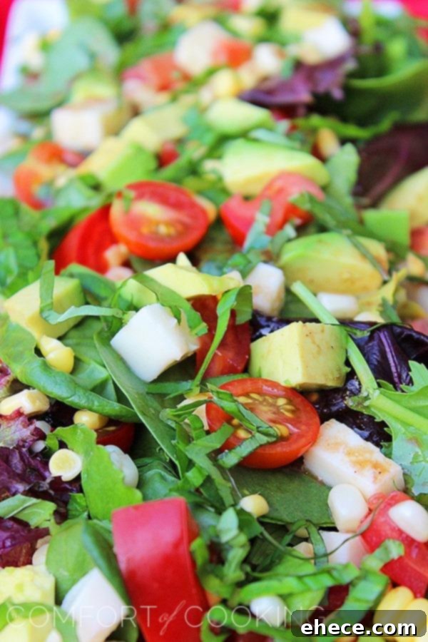 Vibrant Tomato Avocado Corn Basil Salad with Lemon Balsamic Vinaigrette 6 Appetizing photo of Tomato, Avocado, Corn & Basil Salad ready to be served, highlighting its freshness and vibrant colors.
