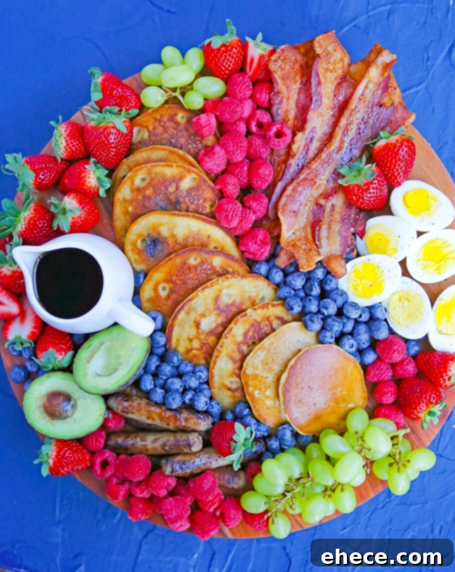 A breakfast board with a festive holiday theme, featuring a variety of pastries, fruits, and small bites arranged artfully.