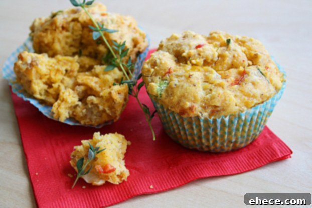 A freshly baked savory breakfast muffin, garnished with fresh herbs.