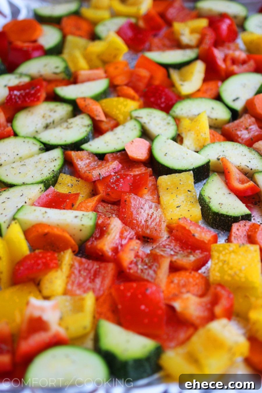 Easy Roasted Summer Vegetables – Close-up of roasted zucchini, peppers, and corn, glistening with olive oil and herbs.