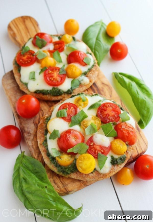 Mini Whole Wheat Pesto Caprese Pizzas – These healthy, colorful pizzas with fresh pesto make for a fun twist on dinner and an easy next-day lunch! | thecomfortofcooking.com