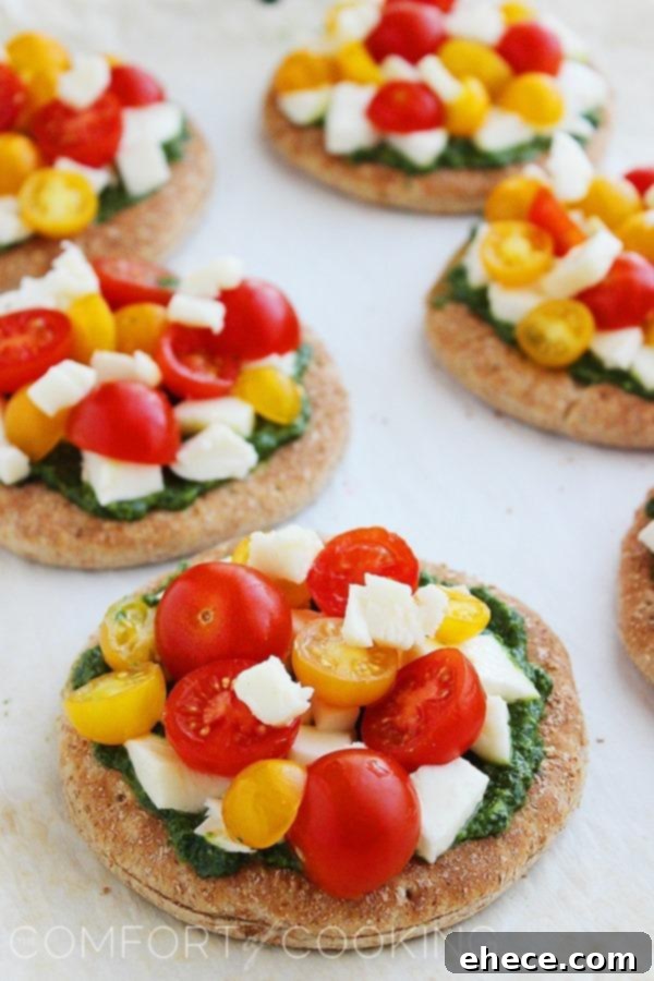 Mini Whole Wheat Pesto Caprese Pizzas – These healthy, colorful pizzas with fresh pesto make for a fun twist on dinner and an easy next-day lunch! | thecomfortofcooking.com