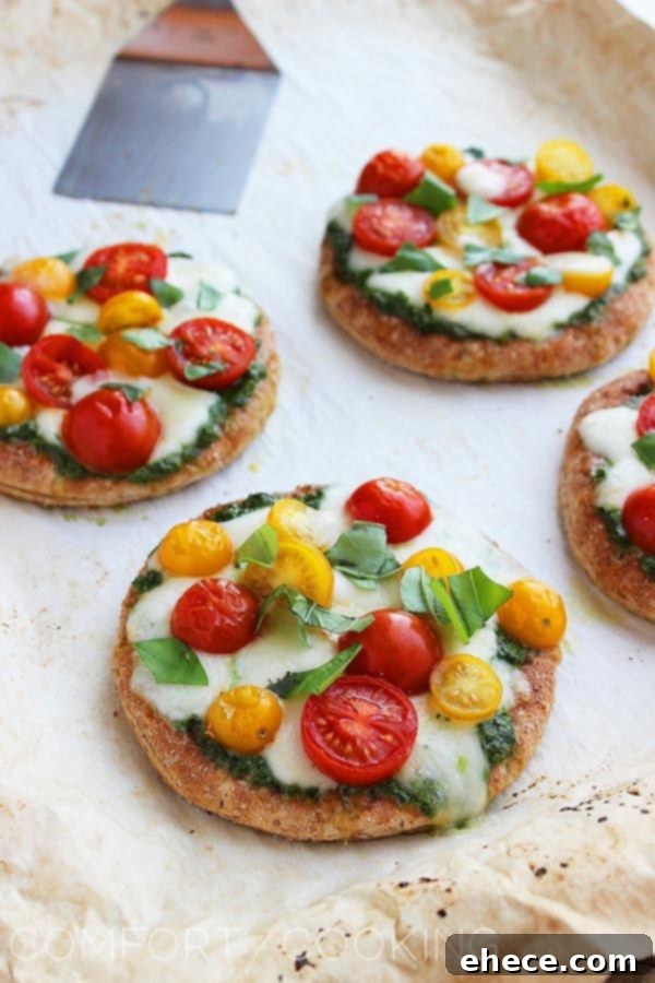Mini Whole Wheat Pesto Caprese Pizzas – These healthy, colorful pizzas with fresh pesto make for a fun twist on dinner and an easy next-day lunch! | thecomfortofcooking.com