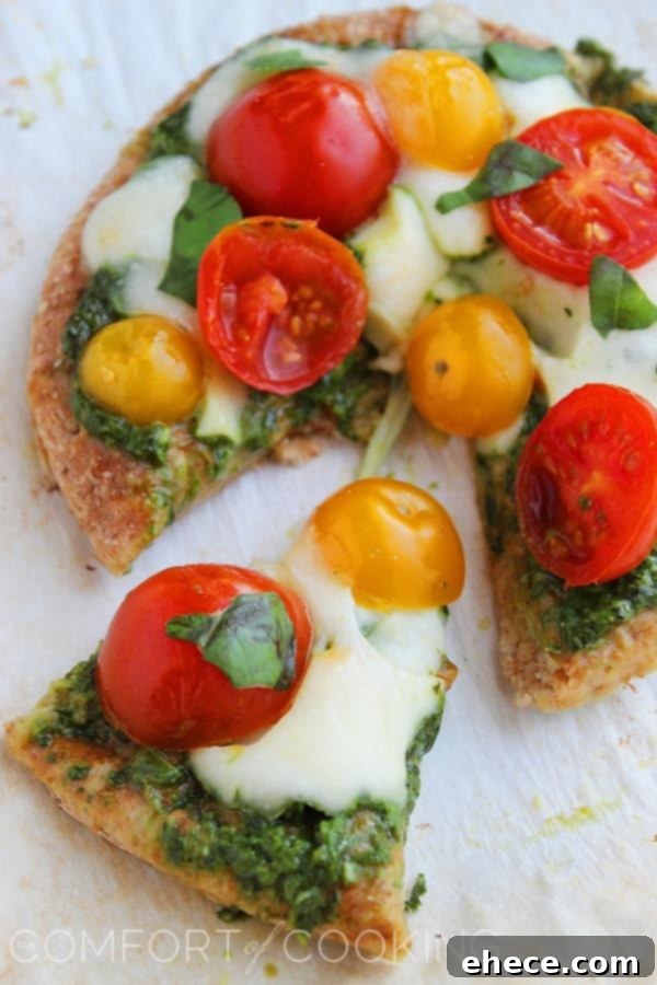 Wholesome Pesto Caprese Mini Pizzas 7 Platter of Mini Whole Wheat Pesto Caprese Pizzas, garnished with fresh basil, ready to be served as an appetizer or light meal.