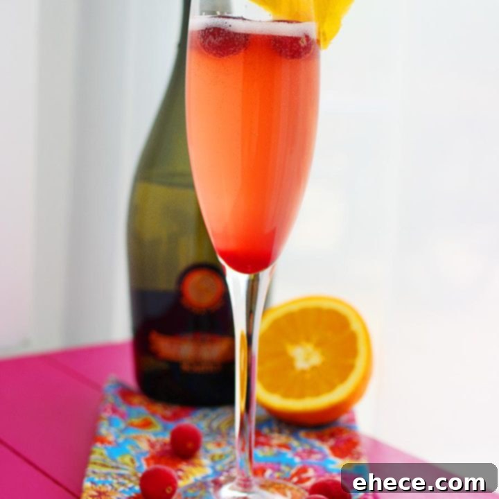 Sparkling Cranberry Orange Bliss 2 Vibrant Cranberry-Orange Prosecco Cocktail in an elegant champagne flute, garnished with fresh cranberries and a delicate orange slice, ready for celebration.