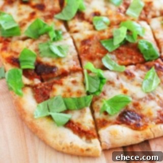 Timeless Margherita Pizza 7 A slice of classic Margherita pizza being lifted from the whole pizza.