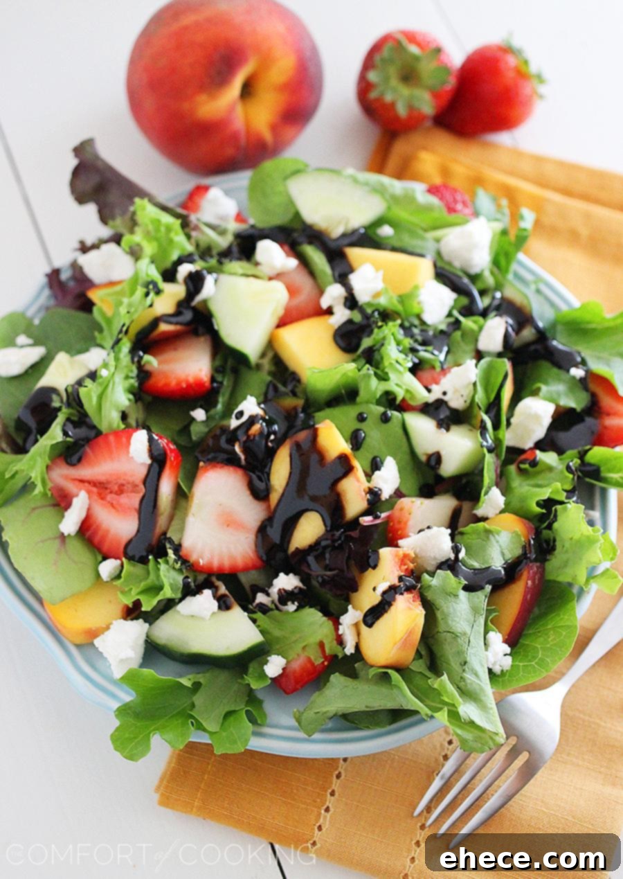 Summer Strawberry-Peach Salad with Goat Cheese – A crisp, refreshing salad with fresh peaches, strawberries, cucumbers, and goat cheese, elegantly presented. Perfect for summer gatherings.