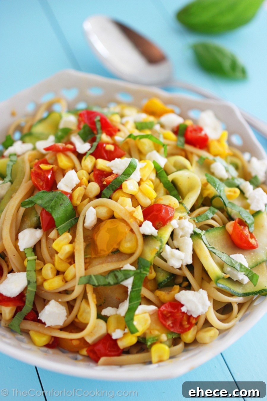 Sun-Kissed Linguine Tossed with Summer Vegetables and Feta 2 A vibrant bowl of Summer Vegetable Linguine with Feta, featuring fresh cherry tomatoes, corn kernels, zucchini ribbons, and basil. A perfect light summer meal.